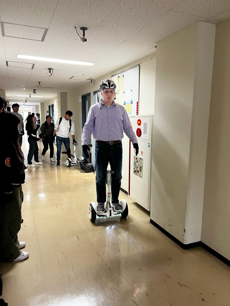 A photo of Jeremy Grifski on a hoverboard at The University of Tsukuba.